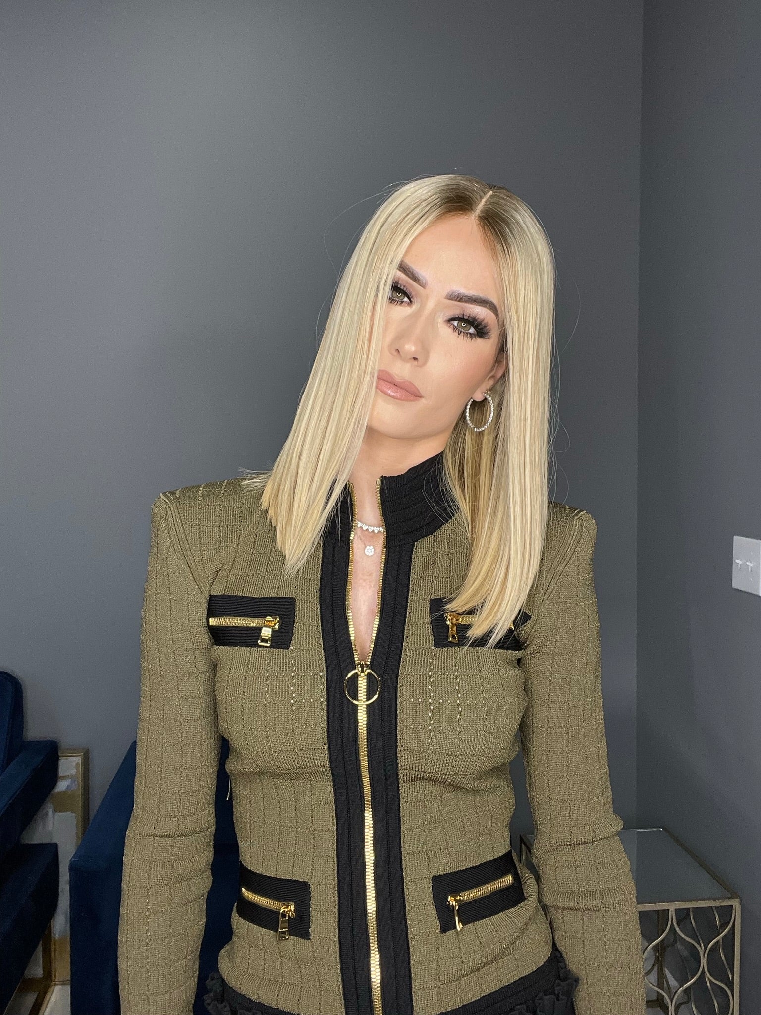 Blonde straight human hair wig with lace top, styled in sleek shoulder-length cut for a chic look.
