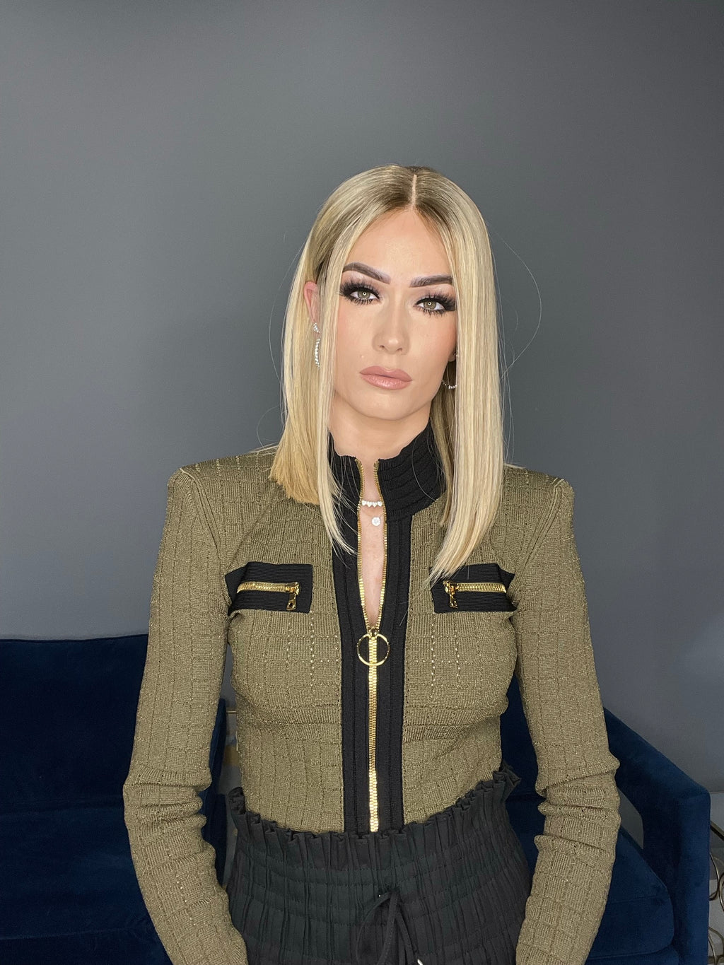 Blonde straight human hair wig with lace top, medium length, styled sleek for a modern look.