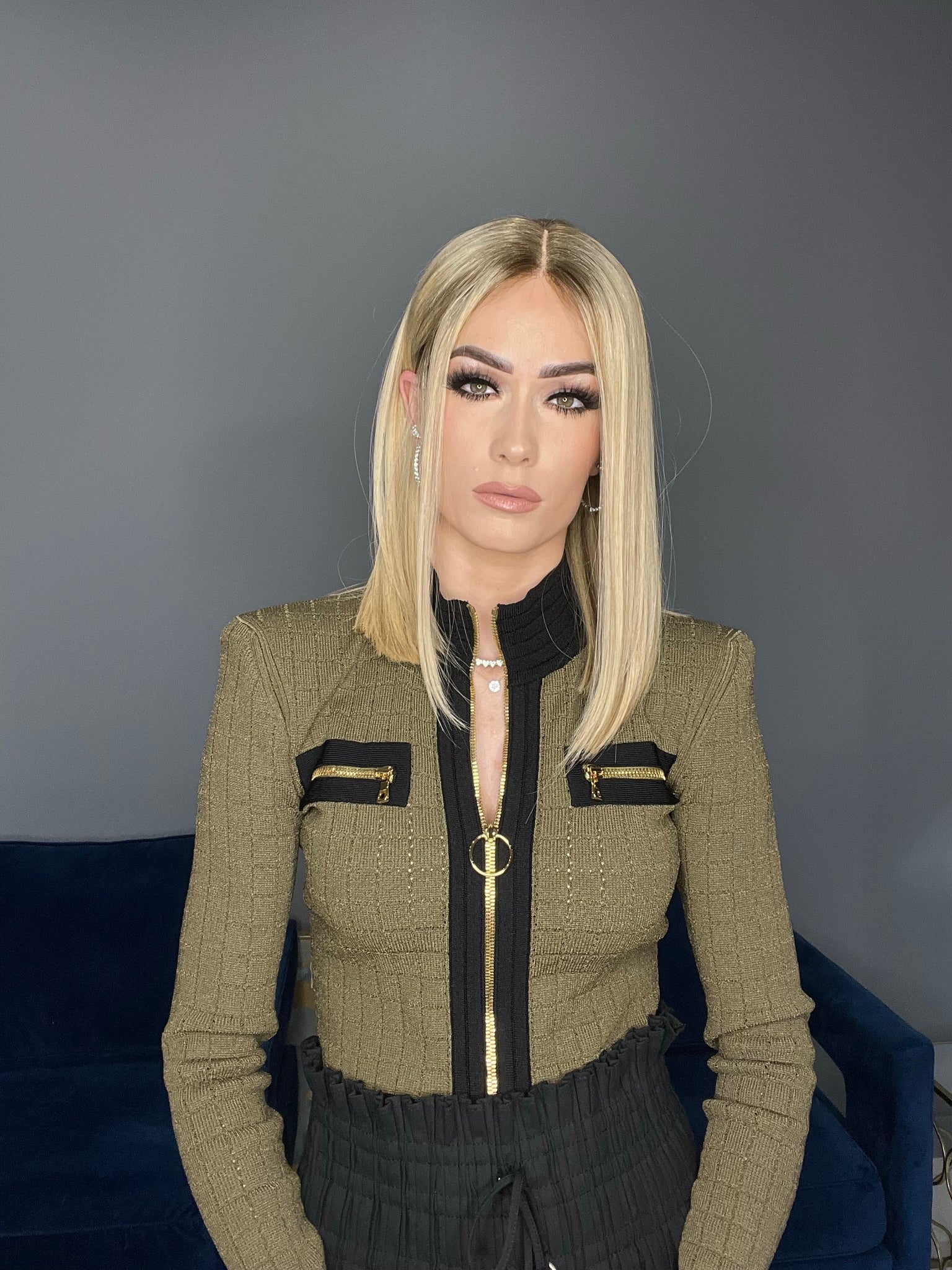 Blonde straight human hair wig with lace top, medium length, styled sleek for a modern look.