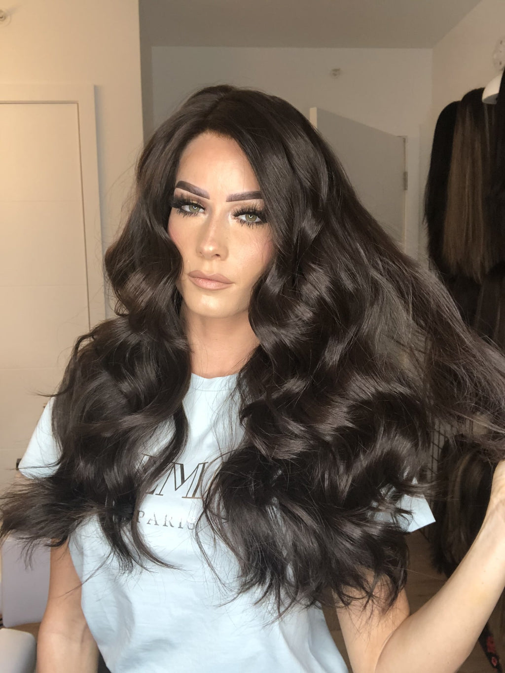 Long dark brown wavy human hair wig with voluminous curls and natural-looking lace top.